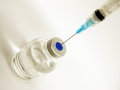 Ampułka ze szczepionką i wbitą igłą